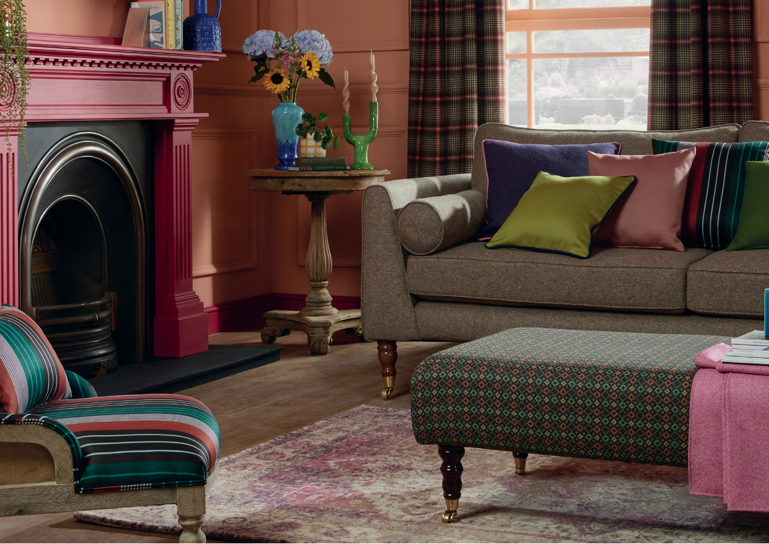 Living room with a sofa, armchair, and fireplace.