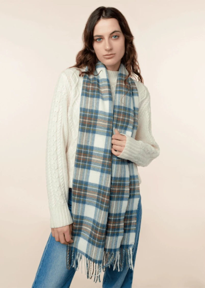 Woman wearing a plaid scarf on a beige background